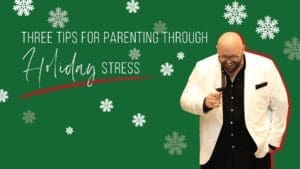 Kristian Livolsi laughing while holding a glass of wine, illustrating tips on how to deal with the holiday stress while parenting.